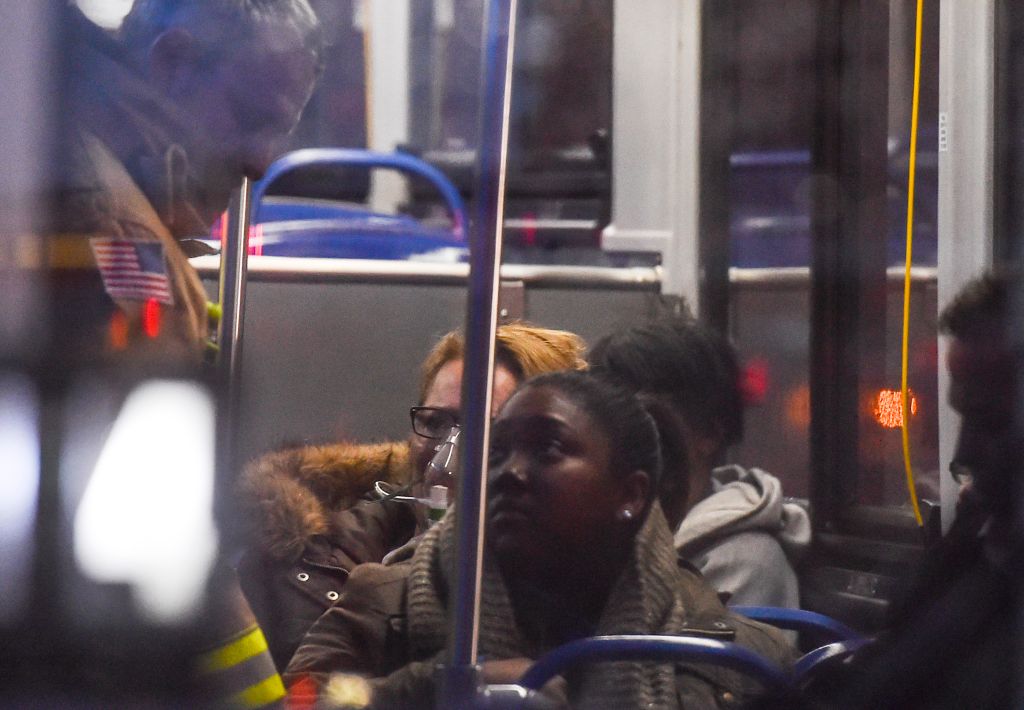 WASHINGTON, DC - JANUARY 12 : A firefighter assists a Metro pas