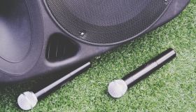 High Angle View Of Microphones And Speaker On Grassy Field