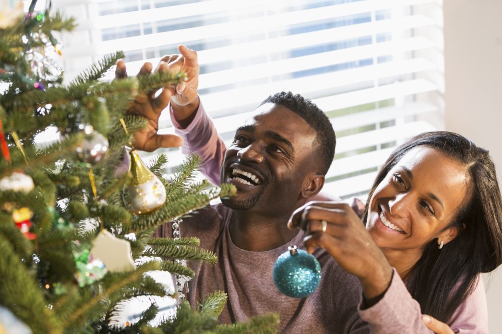 Couple decorating Christmas tree