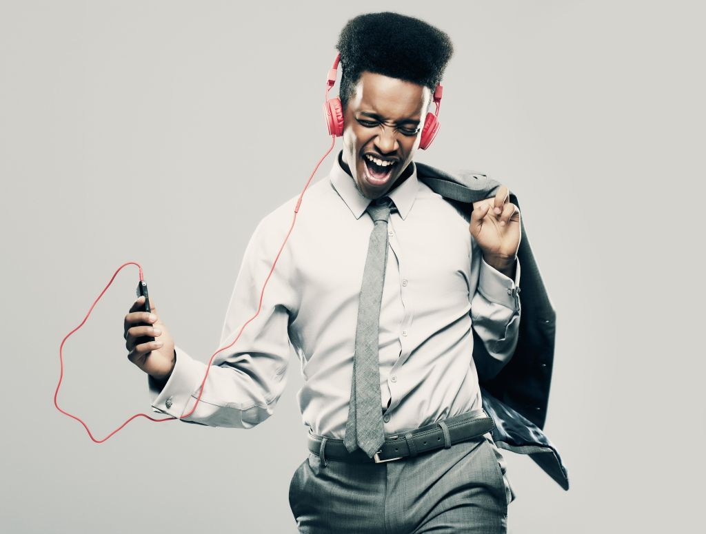 Young Black Male businessman listening to music