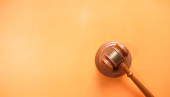 Top View Of Gavel On Orange Background With Copy Space .