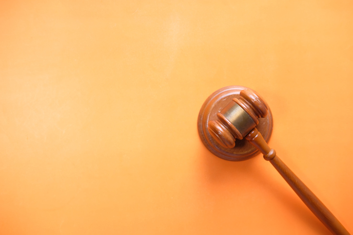 Top View Of Gavel On Orange Background With Copy Space .