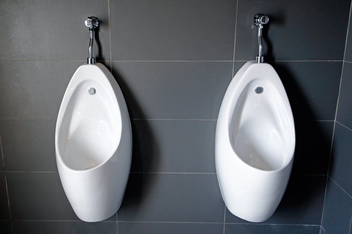 Close up of white urinal toilet blocks in public restroom