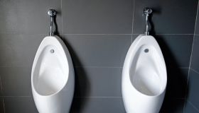 Close up of white urinal toilet blocks in public restroom
