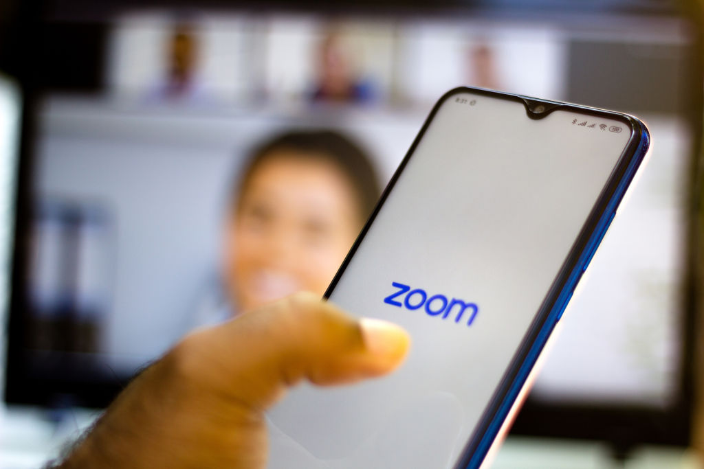In this photo illustration a Zoom Video Communications logo...