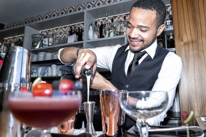 africClose-Up Of Bartender Making Drink On Counter In Baran american making cocktail