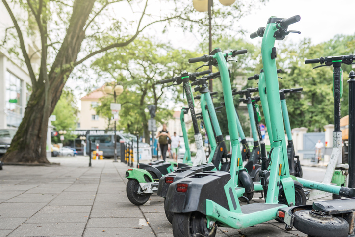 Electric scooter closeup. Parking of motor scooters to ride the city. Urban eco friendly transport concept.