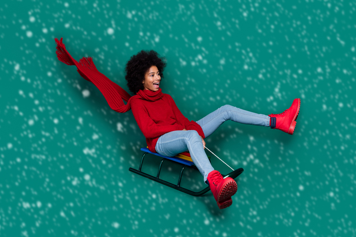 Photo of funny funky little school girl dressed red sweater scarf sledding looking empty space isolated green color background